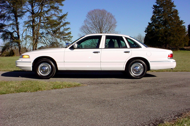 White 1999 Mercury Grand Marquis sedan, side view
