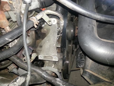 1994 Ford Bronco - Close-up view of engine components including hoses, belts, and pulleys.