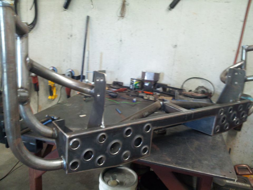 Custom metal fabrication chassis part with multiple circular cutouts