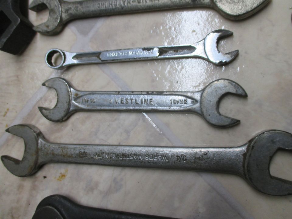 Several metal wrenches with visible text like WESTLINE and WARDS MASTER QUALITY