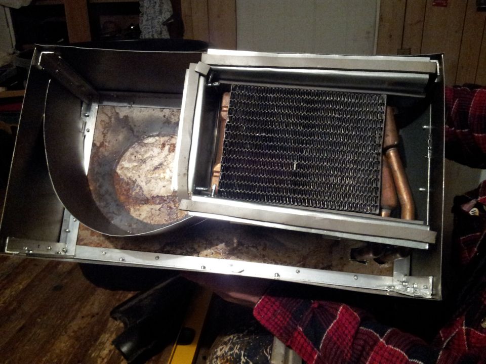 Car heater core assembly with copper tubes and fins inside a metal housing