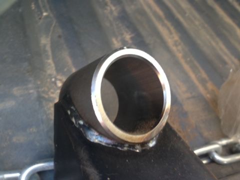 1986 Ford Bronco - A metal part with a tube and bracket is shown, with visible welding and a clean inner edge.