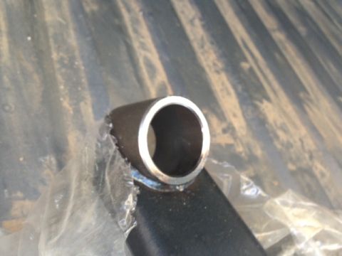 1986 Ford Bronco - A close-up view of a metal tube, possibly a vehicle part, wrapped in plastic.