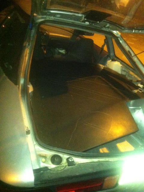 1995 Ford Probe - The interior of a silver car is visible with the trunk open, revealing the rear seats and floor.