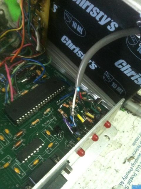 1995 Ford Probe - Electronic circuit board with chips, resistors, and wiring visible, with a gray cable connected.