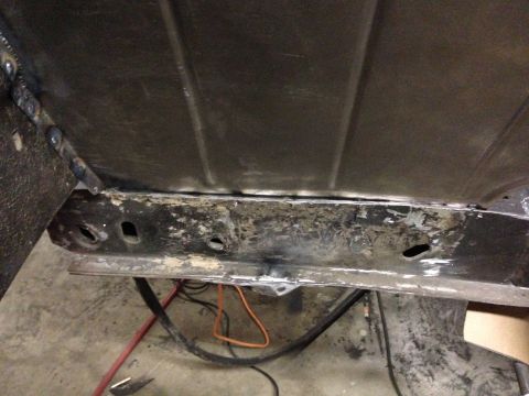 1964 Ford Fairlane - Underside view of a 1964 Ford Fairlane, revealing a corroded frame and fuel tank area.