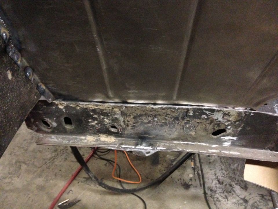 1964 Ford Fairlane undercarriage, showing rusted frame and fuel tank