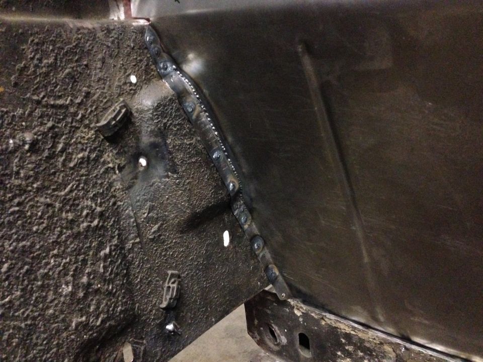 Welded metal panel on vehicle frame