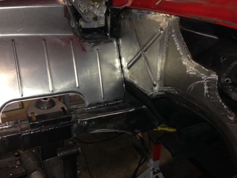 1964 Ford Fairlane - Close-up of a car's floor pan and frame, showing recent metalwork and reinforcements.