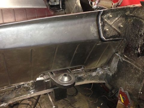 1964 Ford Fairlane - Close-up view of the vehicle's undercarriage, highlighting structural repairs and suspension mounting points.