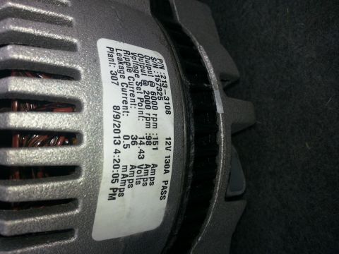 1994 Ford Bronco - Close-up of an alternator's identification label showing part number and test results.