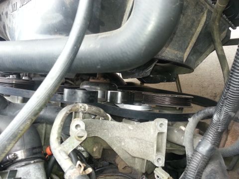1994 Ford Bronco - Close-up view of the engine's belt system, showing pulleys and tensioner.