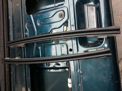 1994 Ford Bronco - Close-up view of the interior of a vehicle door, showing the internal structure and weather seals.