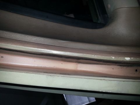 1994 Ford Bronco - This image shows the interior door sill of a vehicle, focusing on the lower trim and surrounding panels.