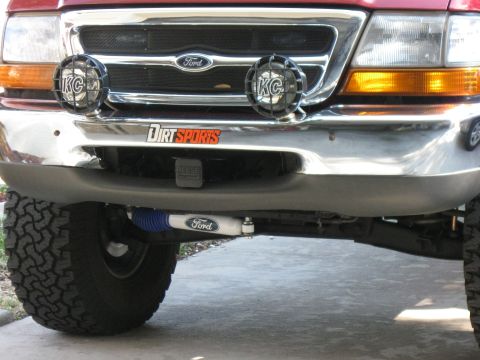1999 Ford Ranger - Front view of a red 1998 Ford Ranger, showing aftermarket lights and a 'Dirt Sports' decal.