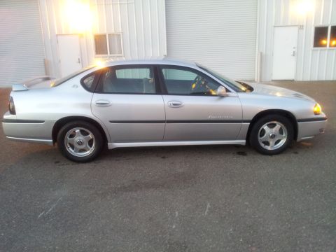 2001 Chevrolet Impala - Silver 2001 Chevrolet Impala sedan parked outdoors. The vehicle is viewed from the side.