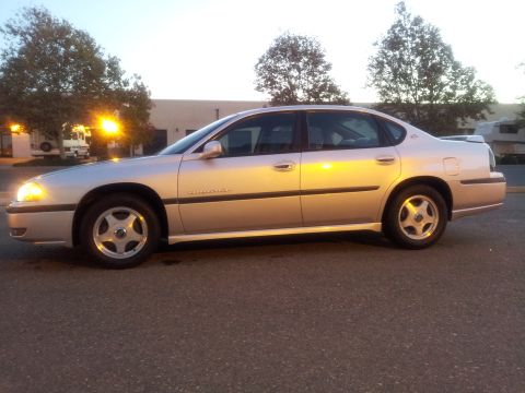 2001 Chevrolet Impala - Side profile of a silver 2001 Chevrolet Impala sedan parked on asphalt.