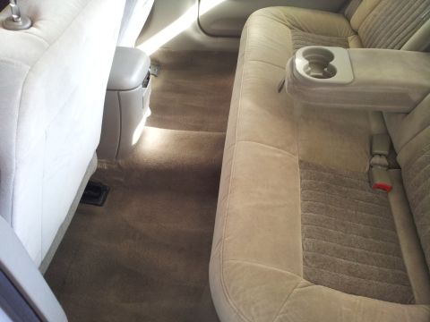 2001 Chevrolet Impala - Interior view of car's rear seating area with tan carpet and upholstery.