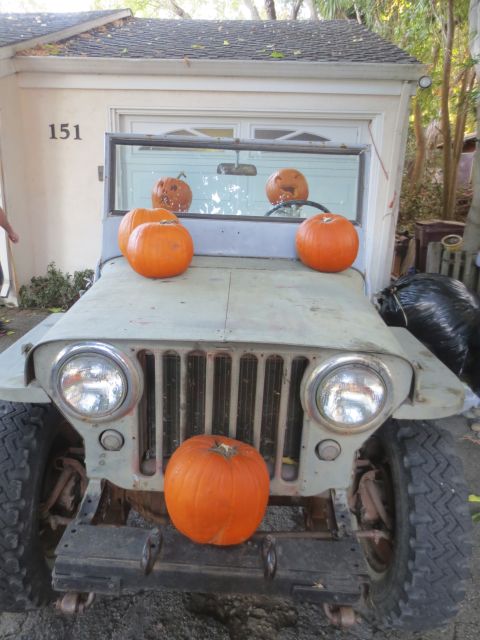 1946 Jeep Willys - A vintage Jeep, likely a 1946 CJ5, is decorated with pumpkins for Halloween.