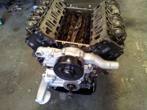 2001 Chevrolet Impala - V8 engine block with water pump and pulley assembly, likely undergoing repair or rebuild.
