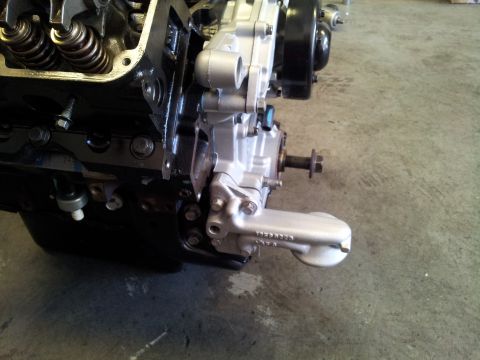 2001 Chevrolet Impala - This is a close-up view of an engine's oil pan and part of the block, showing mechanical components.