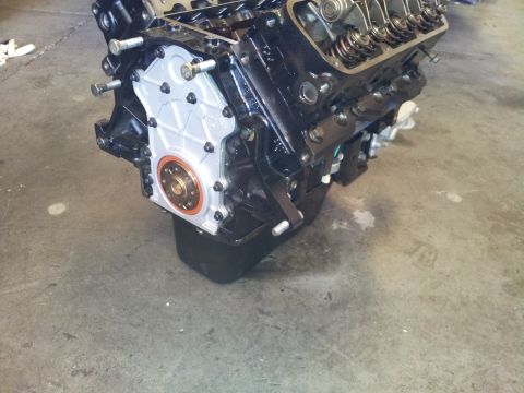 2001 Chevrolet Impala - Close-up view of a rebuilt engine block, showing the front timing cover and oil pan assembly.