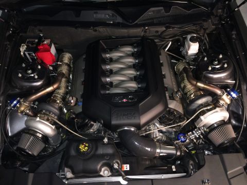 2013 Ford Mustang - Engine bay of a 2013 Ford Mustang a twin-turbocharged V8 engine with visible modifications.