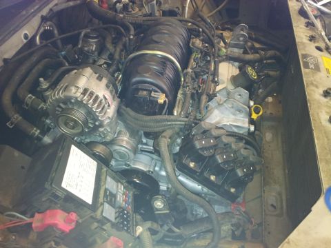 2001 Chevrolet Impala - Close-up view of a vehicle's engine bay, showing various components and wiring.
