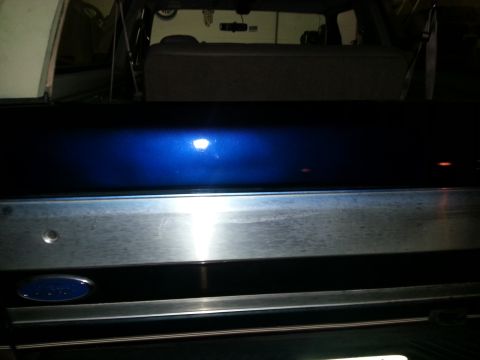 1994 Ford Bronco - Rear view of a blue 1994 Ford Bronco tailgate chrome trim and the Ford emblem.