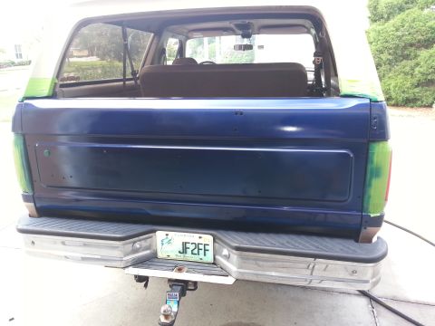 1994 Ford Bronco - Rear view of a blue Ford Bronco, possibly undergoing paint work, with a Florida license plate.
