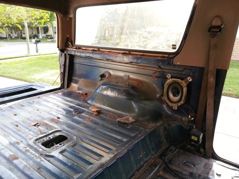 1994 Ford Bronco - The interior of the vehicle shows signs of wear and tear, with rust visible on the floor and side panels.