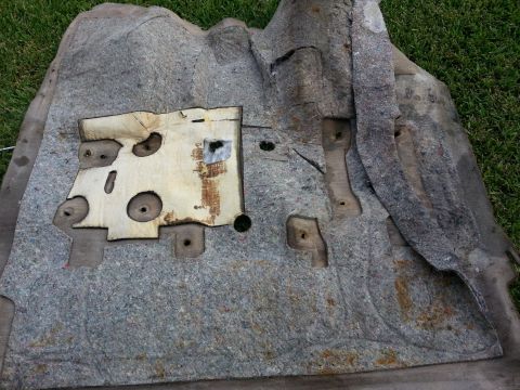 1994 Ford Bronco - This is a car interior insulation panel, likely from the floor or firewall, showing its mounting points and foam insulation.