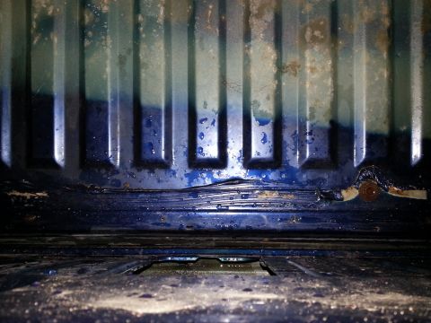1994 Ford Bronco - The floor of the vehicle shows significant rust and wear, with blue paint peeling off.