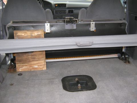 1996 Ford Bronco - The rear cargo area of a 1996 Ford Bronco shows the folded seat and some makeshift wooden supports.