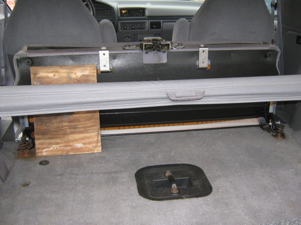 1996 Ford Bronco interior cargo area with folded rear seat and wooden supports