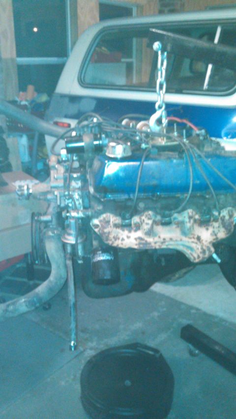 1979 Ford Bronco - Engine removal in progress from a two-tone blue and white vehicle.