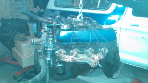 1979 Ford Bronco - Engine removed from a vehicle for repair or maintenance, with another engine block nearby.
