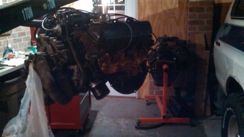 1979 Ford Bronco - Engine removed from a vehicle and placed on an engine stand.