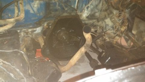 1979 Ford Bronco - Underside view of engine and transmission components, with exhaust pipe and wiring.