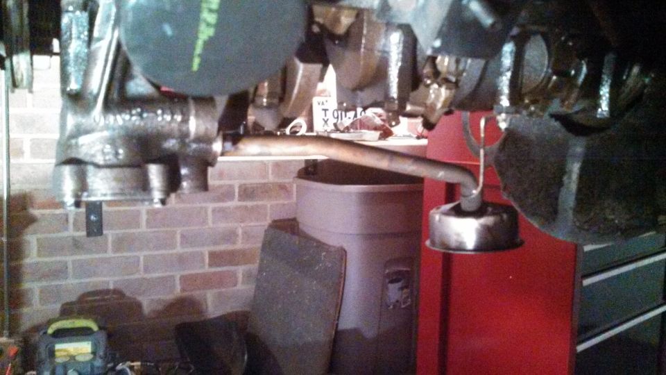 close-up of engine component with metal pipe and cap