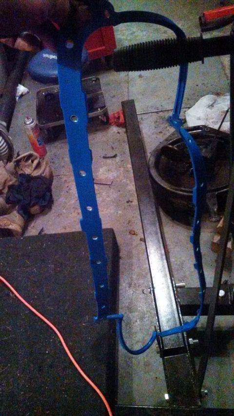 1979 Ford Bronco - A blue gasket is shown hanging in a workshop environment with tools and parts in the background.