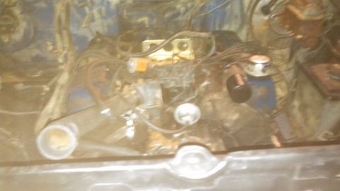1979 Ford Bronco - View of the engine bay, showing the carburetor and various hoses and wiring.
