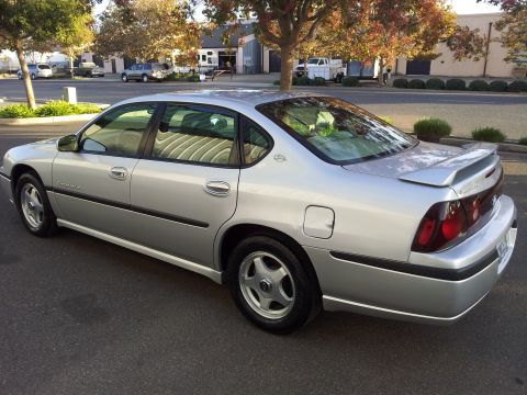 2001 Chevrolet Impala - This silver 2001 Chevrolet Impala sedan is shown from the rear three-quarter angle.