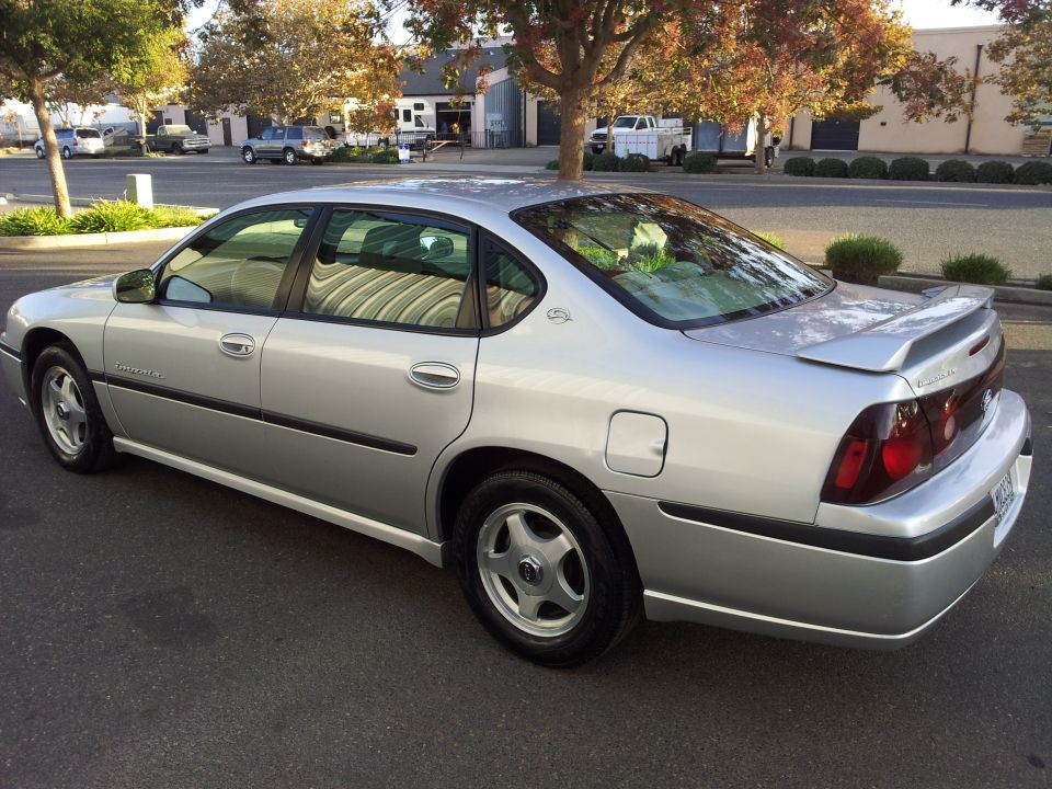 Silver 2001 Chevrolet Impala sedan, rear 3/4 view