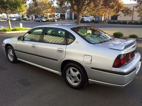 2001 Chevrolet Impala - Silver 2001 Chevrolet Impala sedan with a spoiler, seen from the rear three-quarter angle.