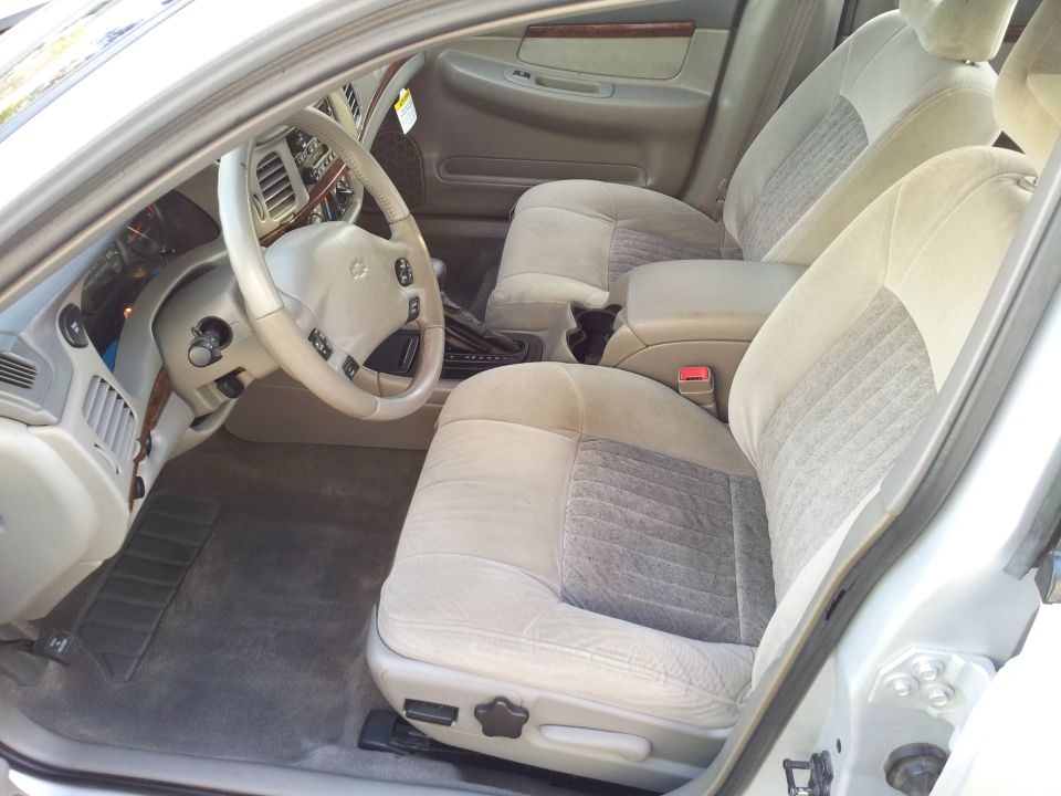 Tan cloth front bucket seats and steering wheel of Chevrolet Impala sedan