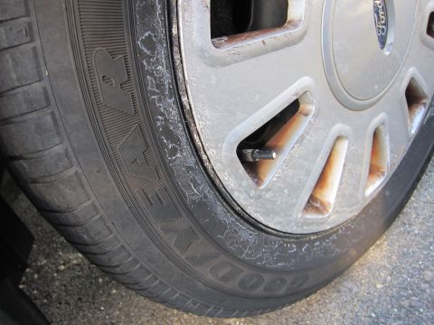 2001 Ford Crown Victoria - Close-up of a Goodyear tire and a silver alloy wheel with a Ford logo.