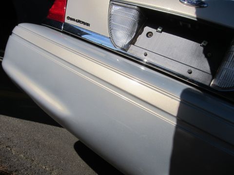 2001 Ford Crown Victoria - Close-up of the rear bumper and taillight assembly on a 2001 Ford Crown Victoria.
