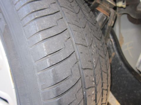 2001 Ford Crown Victoria - The tread on this tire is significantly worn down, showing the wear bars.