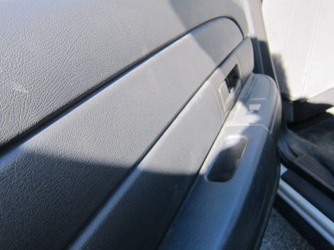 2001 Ford Crown Victoria - Close-up view of the interior door panel, showing the texture and design of the armrest and controls.
